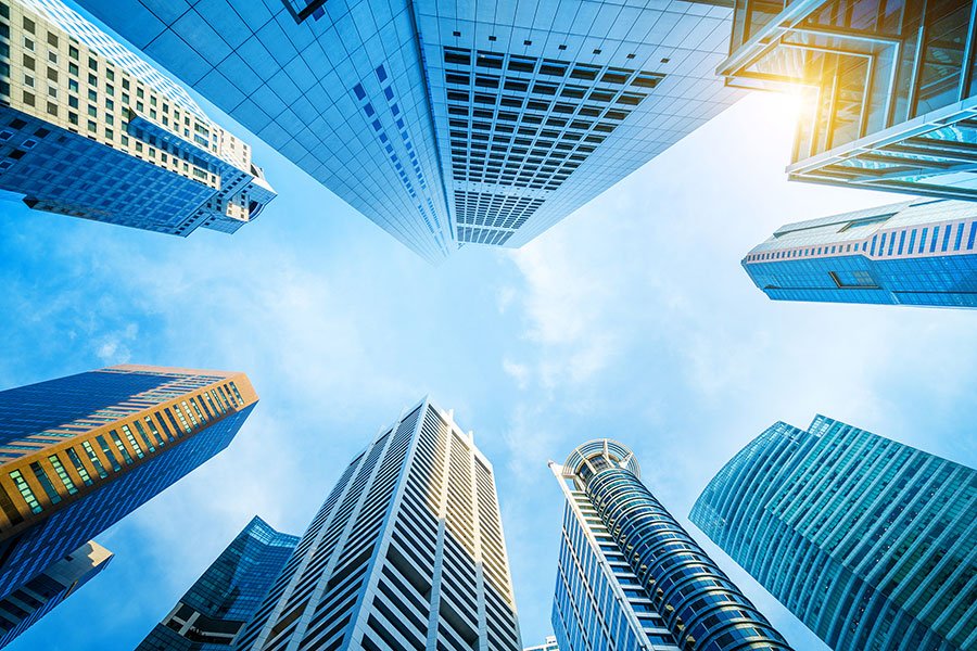Upward view of CBD office buildings in Singapore, representing premium office rental locations surrounded by corporate towers