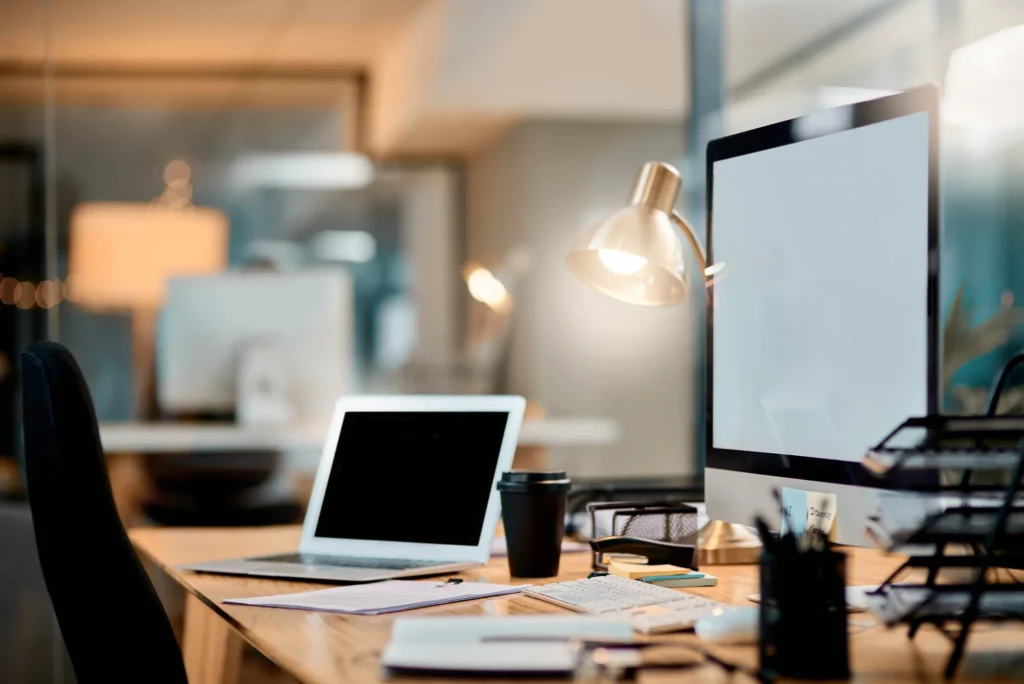 Modern office desk with computer, papers, and pen illustrating why virtual offices are popular in Singapore